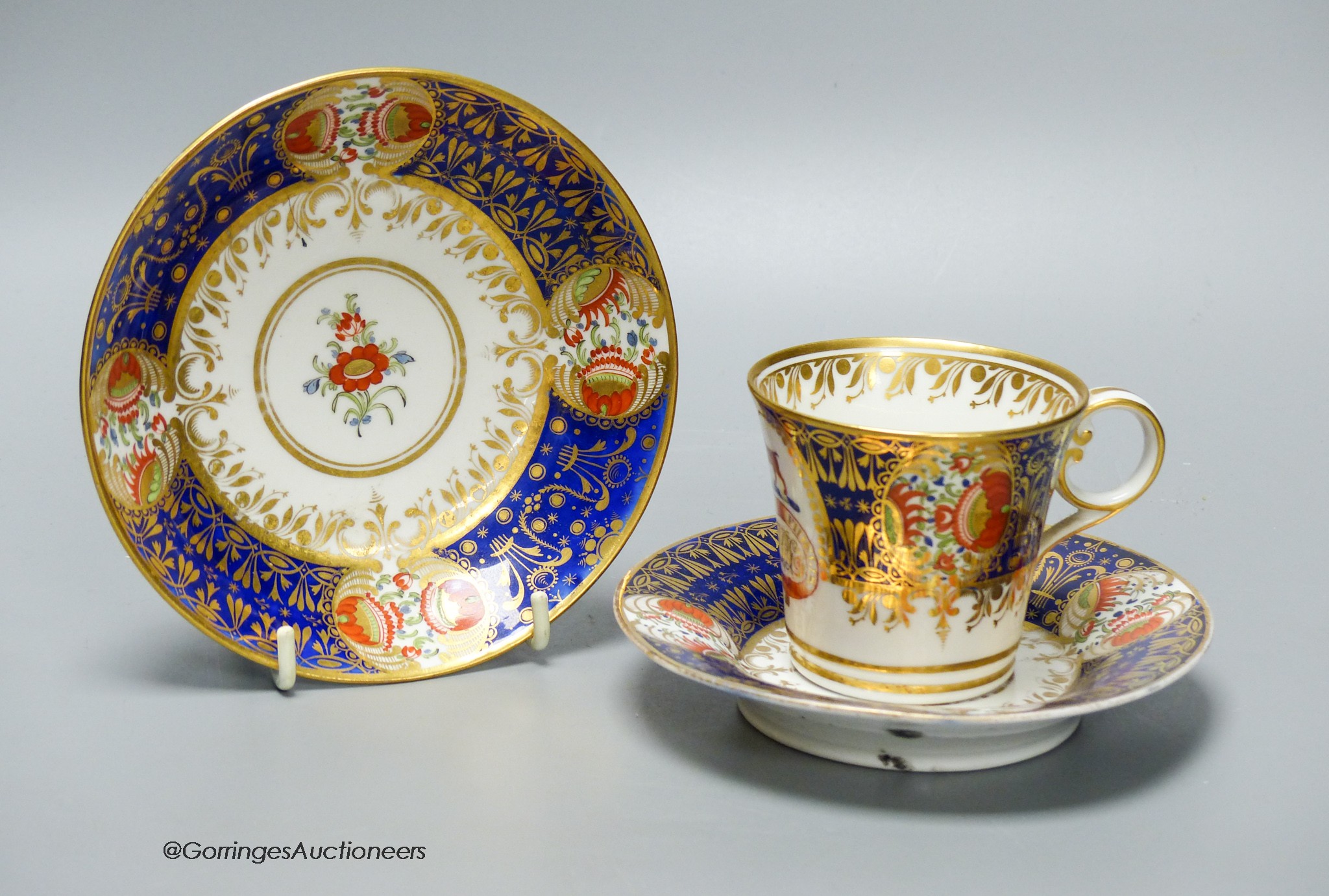 A Chamberlain armorial or crested cup and saucer in the style of the Yeo service and Chamberlain Worcester crested saucer